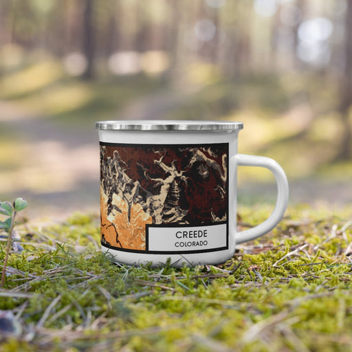 Right View Custom Creede Colorado Map Enamel Mug in Ember on Grass With Trees in Background