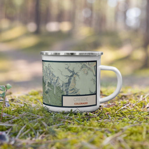 Right View Custom Creede Colorado Map Enamel Mug in Woodblock on Grass With Trees in Background