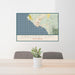 24x36 Crescent City California Map Print Lanscape Orientation in Woodblock Style Behind 2 Chairs Table and Potted Plant