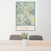 24x36 Crested Butte Colorado Map Print Portrait Orientation in Woodblock Style Behind 2 Chairs Table and Potted Plant