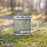 Right View Custom Crestline California Map Enamel Mug in Woodblock on Grass With Trees in Background