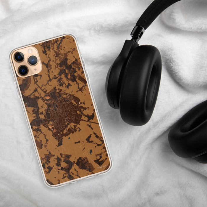 Custom Crockett Texas Map Phone Case in Ember on Table with Black Headphones