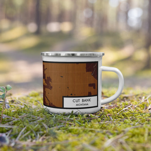 Right View Custom Cut Bank Montana Map Enamel Mug in Ember on Grass With Trees in Background