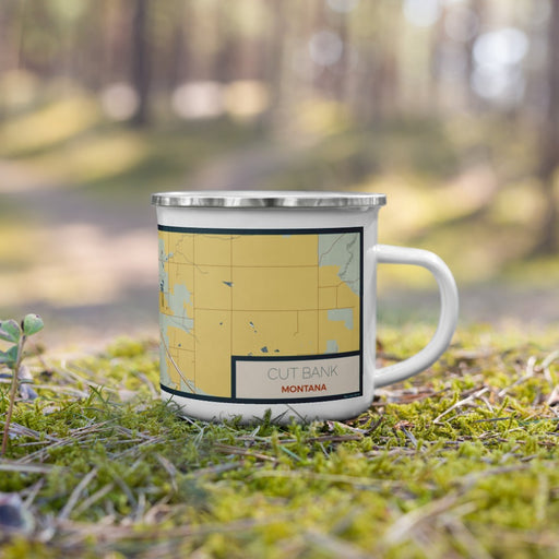 Right View Custom Cut Bank Montana Map Enamel Mug in Woodblock on Grass With Trees in Background