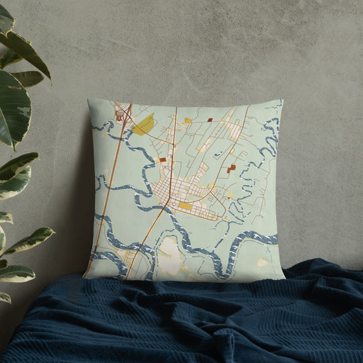 Custom Darien Georgia Map Throw Pillow in Woodblock on Bedding Against Wall