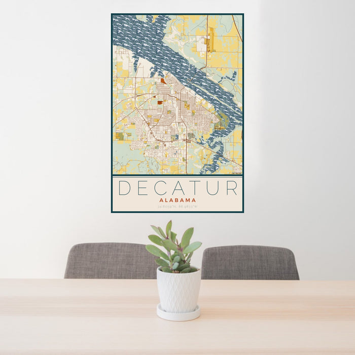 24x36 Decatur Alabama Map Print Portrait Orientation in Woodblock Style Behind 2 Chairs Table and Potted Plant
