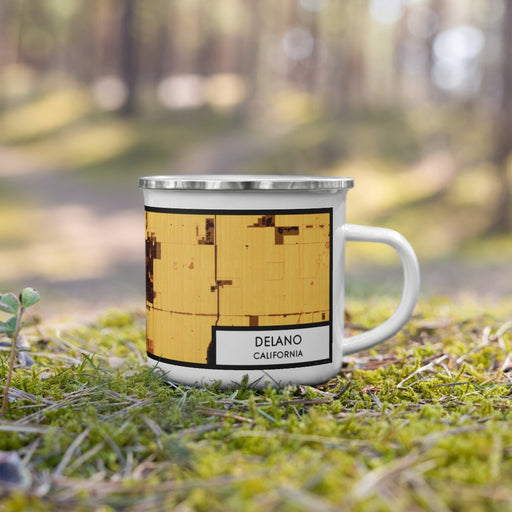 Right View Custom Delano California Map Enamel Mug in Ember on Grass With Trees in Background