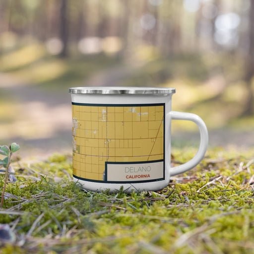Right View Custom Delano California Map Enamel Mug in Woodblock on Grass With Trees in Background