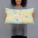 Person holding 20x12 Custom Del Norte Colorado Map Throw Pillow in Woodblock