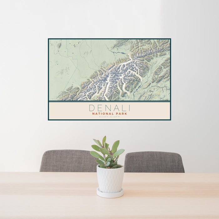 24x36 Denali National Park Map Print Landscape Orientation in Woodblock Style Behind 2 Chairs Table and Potted Plant