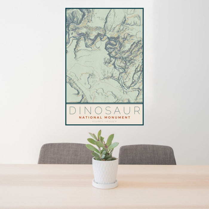 24x36 Dinosaur National Monument Map Print Portrait Orientation in Woodblock Style Behind 2 Chairs Table and Potted Plant