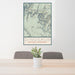 24x36 Dinosaur National Monument Map Print Portrait Orientation in Woodblock Style Behind 2 Chairs Table and Potted Plant