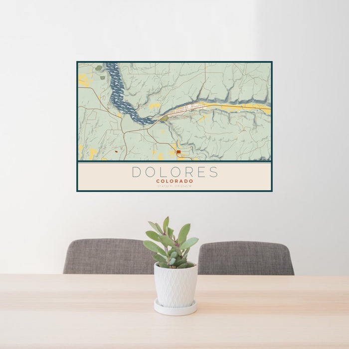 24x36 Dolores Colorado Map Print Lanscape Orientation in Woodblock Style Behind 2 Chairs Table and Potted Plant