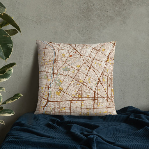 Custom Downey California Map Throw Pillow in Woodblock on Bedding Against Wall