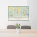 24x36 Dubois Wyoming Map Print Landscape Orientation in Woodblock Style Behind 2 Chairs Table and Potted Plant
