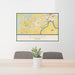 24x36 Dundee Oregon Map Print Landscape Orientation in Woodblock Style Behind 2 Chairs Table and Potted Plant
