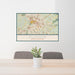 24x36 Durham North Carolina Map Print Landscape Orientation in Woodblock Style Behind 2 Chairs Table and Potted Plant