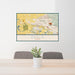 24x36 Eagle Idaho Map Print Landscape Orientation in Woodblock Style Behind 2 Chairs Table and Potted Plant