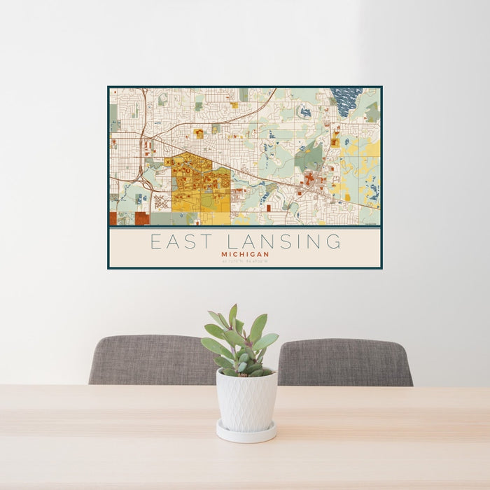 24x36 East Lansing Michigan Map Print Landscape Orientation in Woodblock Style Behind 2 Chairs Table and Potted Plant