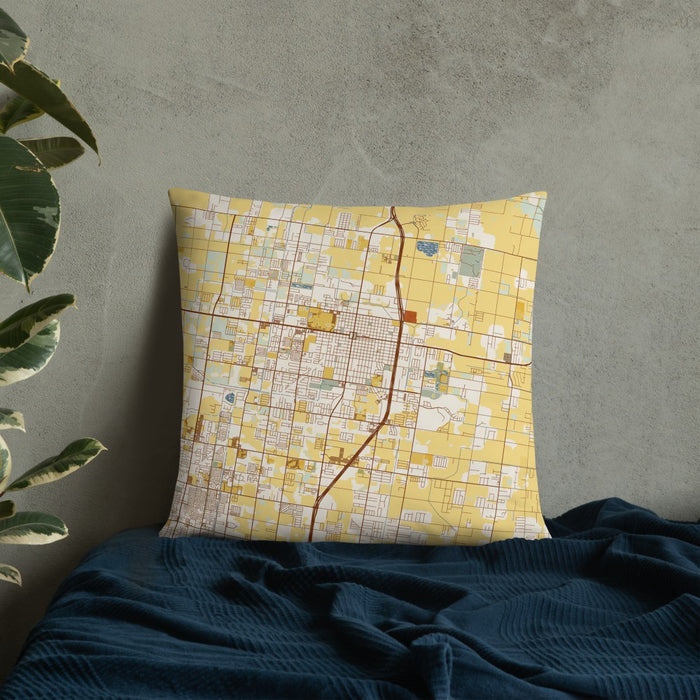 Custom Edinburg Texas Map Throw Pillow in Woodblock on Bedding Against Wall