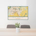 24x36 Elk Grove California Map Print Lanscape Orientation in Woodblock Style Behind 2 Chairs Table and Potted Plant