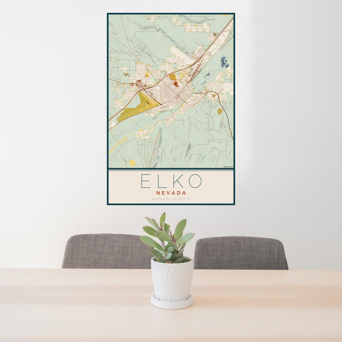 24x36 Elko Nevada Map Print Portrait Orientation in Woodblock Style Behind 2 Chairs Table and Potted Plant