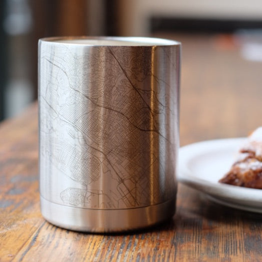 10oz Stainless Steel Insulated Cup with Custom Engraved Map on Table next to Pastry
