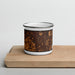 Front View Custom Elyria Ohio Map Enamel Mug in Ember on Cutting Board