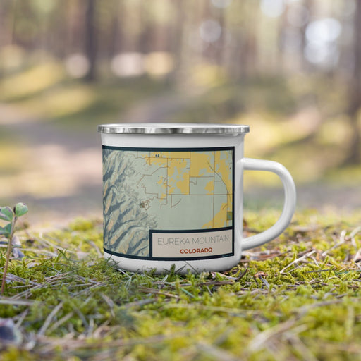 Right View Custom Eureka Mountain Colorado Map Enamel Mug in Woodblock on Grass With Trees in Background