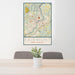 24x36 Fairmont West Virginia Map Print Portrait Orientation in Woodblock Style Behind 2 Chairs Table and Potted Plant