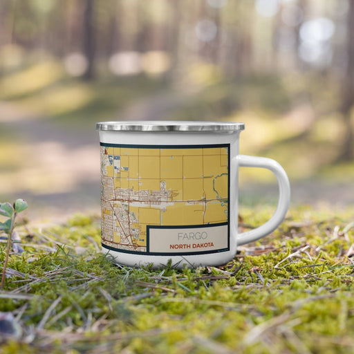 Right View Custom Fargo North Dakota Map Enamel Mug in Woodblock on Grass With Trees in Background