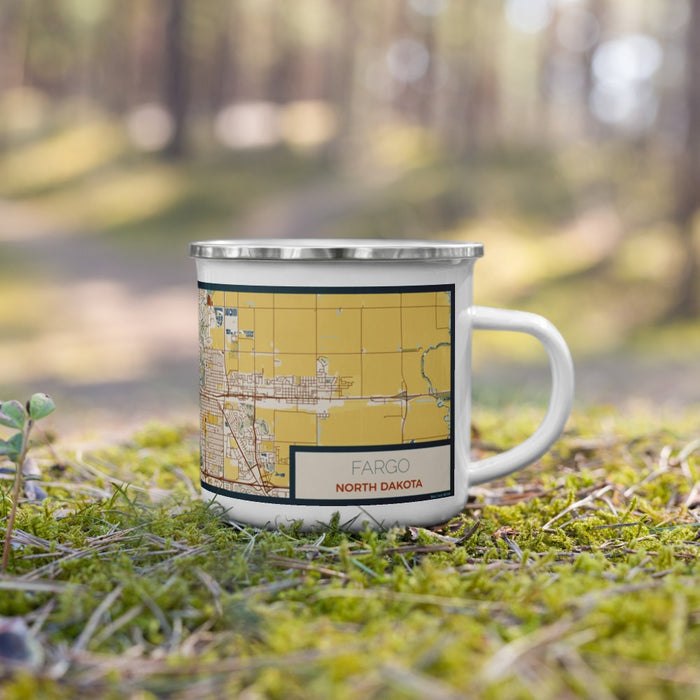 Right View Custom Fargo North Dakota Map Enamel Mug in Woodblock on Grass With Trees in Background