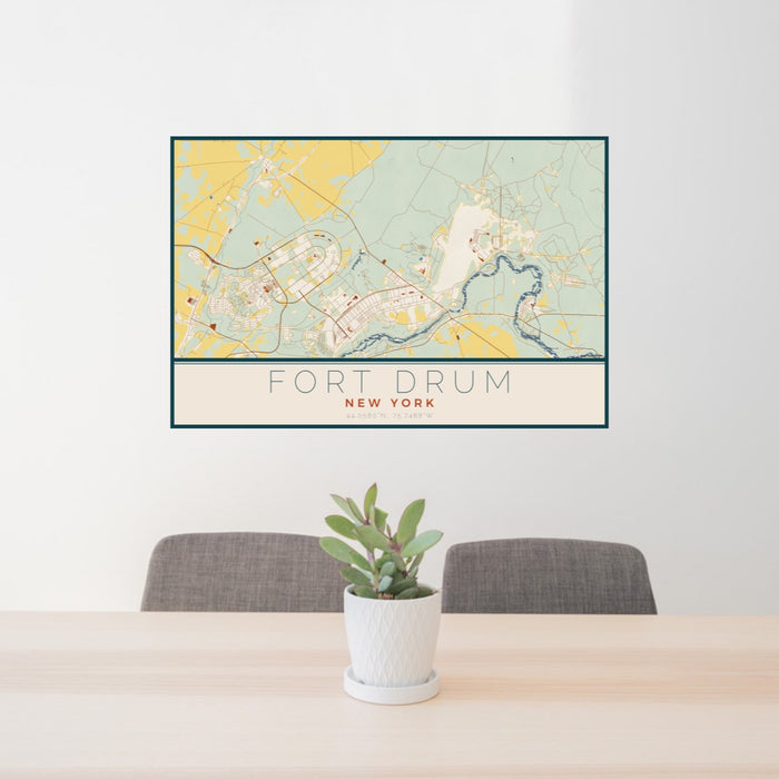 24x36 Fort Drum New York Map Print Lanscape Orientation in Woodblock Style Behind 2 Chairs Table and Potted Plant