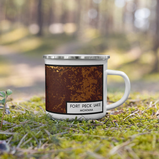 Right View Custom Fort Peck Lake Montana Map Enamel Mug in Ember on Grass With Trees in Background