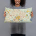 Person holding 20x12 Custom Gainesville Florida Map Throw Pillow in Woodblock