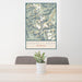24x36 Gannett Peak Wyoming Map Print Portrait Orientation in Woodblock Style Behind 2 Chairs Table and Potted Plant