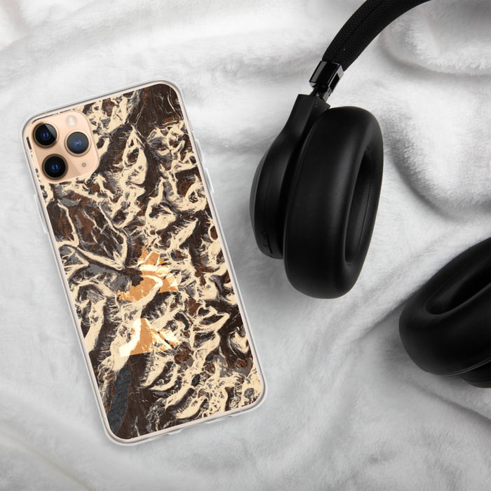 Custom Glacier National Park Map Phone Case in Ember on Table with Black Headphones