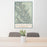 24x36 Glacier National Park Map Print Portrait Orientation in Woodblock Style Behind 2 Chairs Table and Potted Plant