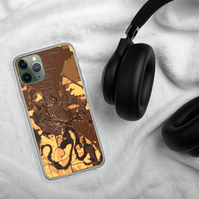 Custom Glasgow Montana Map Phone Case in Ember on Table with Black Headphones