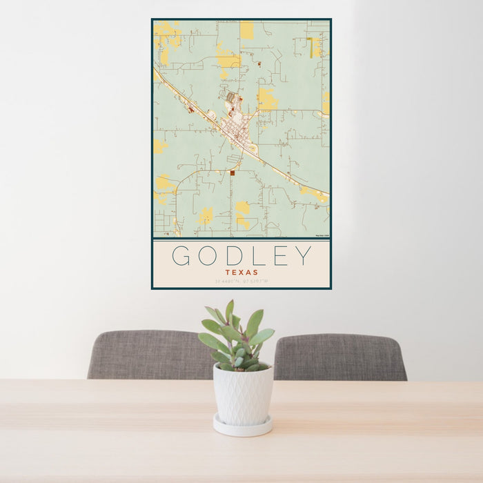 24x36 Godley Texas Map Print Portrait Orientation in Woodblock Style Behind 2 Chairs Table and Potted Plant