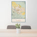 24x36 Grand Junction Colorado Map Print Portrait Orientation in Woodblock Style Behind 2 Chairs Table and Potted Plant