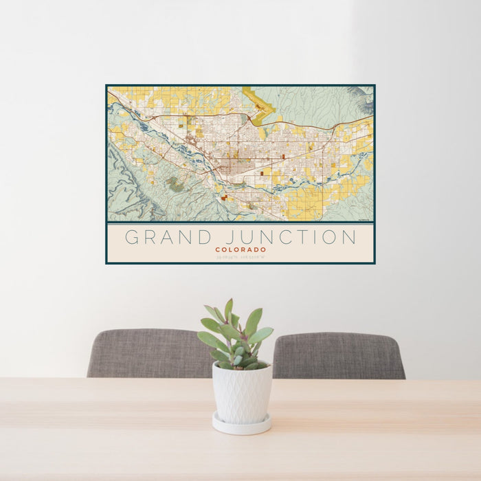 24x36 Grand Junction Colorado Map Print Landscape Orientation in Woodblock Style Behind 2 Chairs Table and Potted Plant