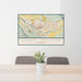 24x36 Grand Junction Colorado Map Print Landscape Orientation in Woodblock Style Behind 2 Chairs Table and Potted Plant