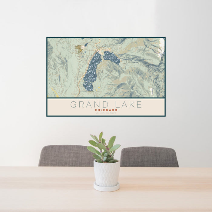 24x36 Grand Lake Colorado Map Print Lanscape Orientation in Woodblock Style Behind 2 Chairs Table and Potted Plant