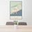 24x36 Grand Marais Minnesota Map Print Portrait Orientation in Woodblock Style Behind 2 Chairs Table and Potted Plant