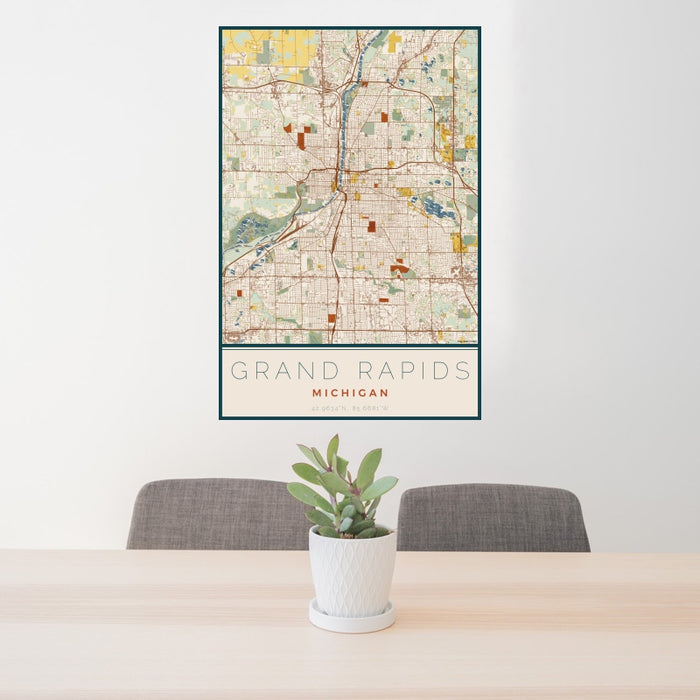 24x36 Grand Rapids Michigan Map Print Portrait Orientation in Woodblock Style Behind 2 Chairs Table and Potted Plant
