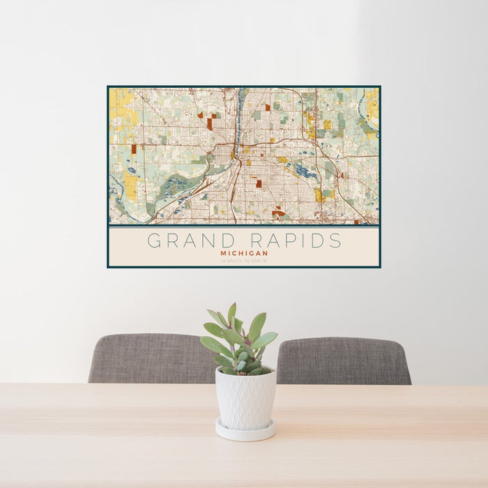 24x36 Grand Rapids Michigan Map Print Landscape Orientation in Woodblock Style Behind 2 Chairs Table and Potted Plant