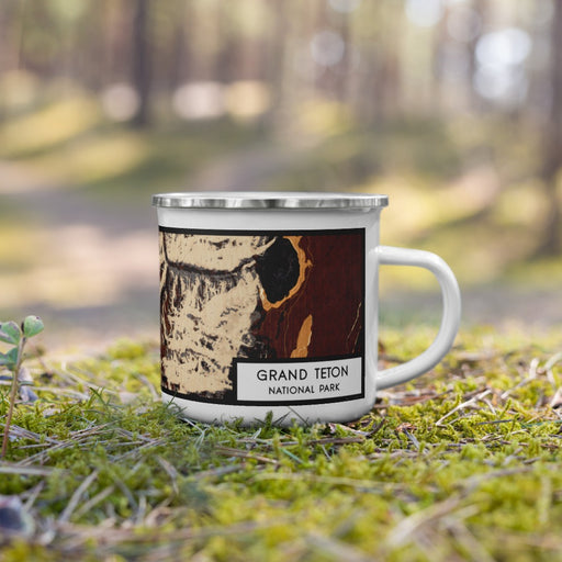 Right View Custom Grand Teton National Park Map Enamel Mug in Ember on Grass With Trees in Background
