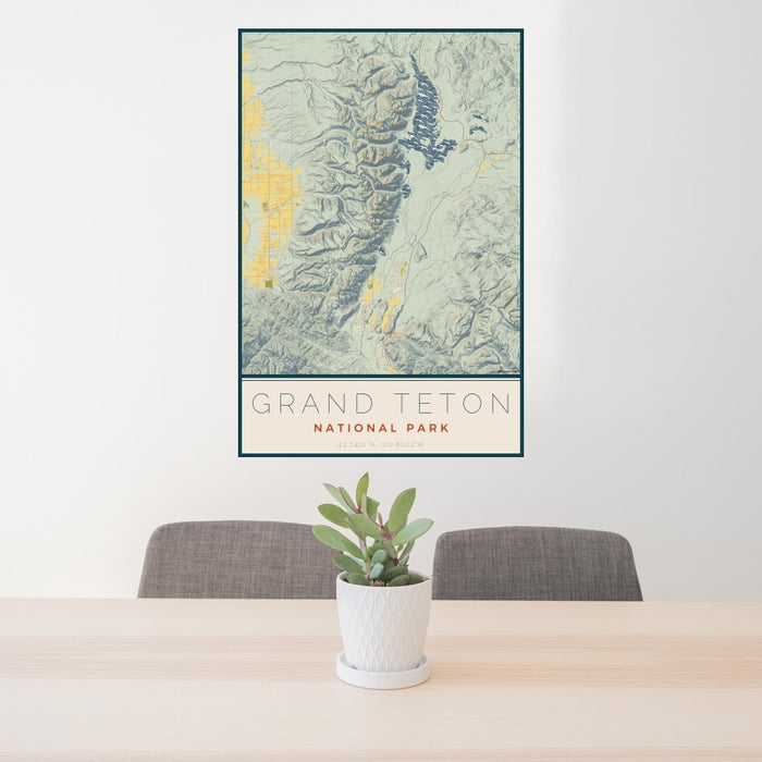 24x36 Grand Teton National Park Map Print Portrait Orientation in Woodblock Style Behind 2 Chairs Table and Potted Plant