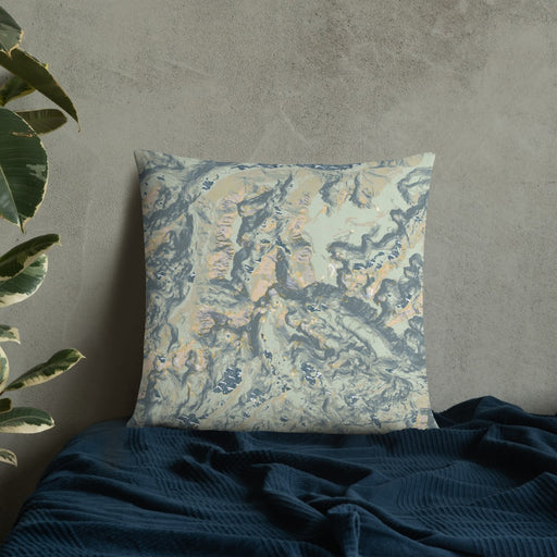Custom Granite Peak Montana Map Throw Pillow in Woodblock on Bedding Against Wall